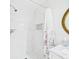 Bright bathroom featuring a tiled shower with a shower niche, and a shower curtain at 14191 Se 25Th Ave, Summerfield, FL 34491