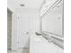 Bright bathroom vanity with marble countertop, storage, and open closet at 14191 Se 25Th Ave, Summerfield, FL 34491
