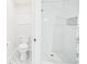 Bathroom featuring a new toilet, tile floors, and a tiled shower with niche at 14191 Se 25Th Ave, Summerfield, FL 34491