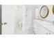 Bright bathroom with a tiled shower, patterned floors, and a white vanity with storage at 14191 Se 25Th Ave, Summerfield, FL 34491