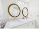 Bathroom with marble countertops, double sinks, and a view of a door at 14191 Se 25Th Ave, Summerfield, FL 34491