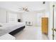 Spacious bedroom with tile floors, ceiling fan, and natural light at 14191 Se 25Th Ave, Summerfield, FL 34491