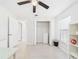 Bright bedroom features an open closet, tile floors, and a ceiling fan at 14191 Se 25Th Ave, Summerfield, FL 34491