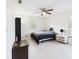 Bright bedroom with a ceiling fan, large window, and tile flooring at 14191 Se 25Th Ave, Summerfield, FL 34491