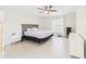 Bright bedroom features tile floors, ceiling fan, and natural light at 14191 Se 25Th Ave, Summerfield, FL 34491