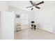 Bright bedroom features tile floors, a ceiling fan, and a desk at 14191 Se 25Th Ave, Summerfield, FL 34491