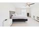 Spacious bedroom with tile floors, ceiling fan, and natural light at 14191 Se 25Th Ave, Summerfield, FL 34491