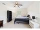 Bright bedroom with a ceiling fan and tile flooring at 14191 Se 25Th Ave, Summerfield, FL 34491