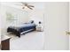 Bright bedroom with a ceiling fan and large window at 14191 Se 25Th Ave, Summerfield, FL 34491