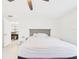 Bright bedroom with tile floors, ceiling fan, and natural light at 14191 Se 25Th Ave, Summerfield, FL 34491