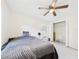 Neutral bedroom with ceiling fan, natural light, and closet at 14191 Se 25Th Ave, Summerfield, FL 34491