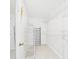 Walk-in closet with white wire shelving, light tile floors, and a view to the bedroom at 14191 Se 25Th Ave, Summerfield, FL 34491