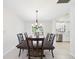Formal dining room with chandelier and adjacent kitchen with stainless appliances at 14191 Se 25Th Ave, Summerfield, FL 34491