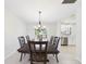 Formal dining room with chandelier and adjacent kitchen with stainless appliances at 14191 Se 25Th Ave, Summerfield, FL 34491