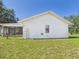 Exterior view showcasing the screened lanai and well-kept lawn at 14191 Se 25Th Ave, Summerfield, FL 34491