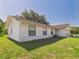 Rear view of home featuring white painted brick wall and attached garage at 14191 Se 25Th Ave, Summerfield, FL 34491