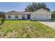 Charming single-story home with a well-maintained lawn and a two-car garage at 14191 Se 25Th Ave, Summerfield, FL 34491