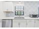Kitchen with stainless steel appliances, quartz countertops, decorative backsplash, and white cabinets at 14191 Se 25Th Ave, Summerfield, FL 34491