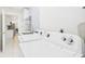 Bright laundry room features modern appliances and decorative tile backsplash at 14191 Se 25Th Ave, Summerfield, FL 34491