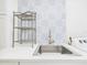 Bright laundry room with patterned wall, sink, and modern appliances at 14191 Se 25Th Ave, Summerfield, FL 34491