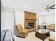 Well-lit living room with tile flooring, fireplace, and large windows for natural light at 14191 Se 25Th Ave, Summerfield, FL 34491