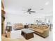 Bright living room boasts tile flooring, fireplace, and easy access to the kitchen and dining area at 14191 Se 25Th Ave, Summerfield, FL 34491