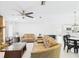 Open-concept living room with tile flooring, brick fireplace, and seamless flow to kitchen and dining spaces at 14191 Se 25Th Ave, Summerfield, FL 34491