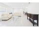 Sunlit living room featuring tiled floors and comfortable seating at 14191 Se 25Th Ave, Summerfield, FL 34491