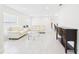 Open concept living room with neutral furniture and plenty of natural light at 14191 Se 25Th Ave, Summerfield, FL 34491