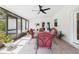 Enclosed patio featuring a ceiling fan, tile flooring, and dining set perfect for outdoor relaxation at 14191 Se 25Th Ave, Summerfield, FL 34491