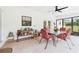 Enclosed patio with a view of the garden, furnished with outdoor seating and decorative plants at 14191 Se 25Th Ave, Summerfield, FL 34491