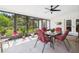 Enclosed patio with a ceiling fan and a table, perfect for outdoor dining at 14191 Se 25Th Ave, Summerfield, FL 34491