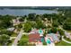 Aerial of home, close to lake and surrounded by large trees, in residential neighborhood at 1491 Avenue F Ne, Winter Haven, FL 33881