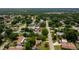 Bird's eye view of a house nestled among dense trees in a quiet residential area at 1491 Avenue F Ne, Winter Haven, FL 33881