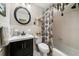 Well-maintained bathroom with a sleek vanity, patterned shower curtain, and classic fixtures at 1491 Avenue F Ne, Winter Haven, FL 33881