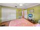 Comfortable bedroom features ample closet space, TV and natural light at 1491 Avenue F Ne, Winter Haven, FL 33881