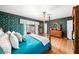 Bright bedroom with backyard access, featuring a four-poster bed and wooden floors at 1491 Avenue F Ne, Winter Haven, FL 33881