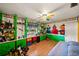 Spacious bedroom with colorful built-in storage, cartoon wall art, and hardwood floors at 1491 Avenue F Ne, Winter Haven, FL 33881