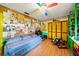 Whimsical bedroom design with cartoon wall art, corkboard accents, and colorful furniture at 1491 Avenue F Ne, Winter Haven, FL 33881