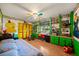 Bright bedroom design with yellow accents, built-in shelves and drawers, and unique cartoon wall art at 1491 Avenue F Ne, Winter Haven, FL 33881