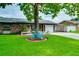 Charming single-story home with a vibrant green lawn, mature trees, and a cute turquoise bicycle decoration at 1491 Avenue F Ne, Winter Haven, FL 33881