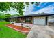 Well-maintained single-story home featuring a brick facade, white picket fence, and a covered front entrance at 1491 Avenue F Ne, Winter Haven, FL 33881
