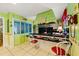 A colorful eat-in kitchen boasts a black tile countertop and island seating at 1491 Avenue F Ne, Winter Haven, FL 33881