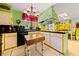 Bright kitchen with black countertops, colorful cabinets, and fun hanging light fixture at 1491 Avenue F Ne, Winter Haven, FL 33881