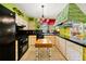 This colorful kitchen has a black oven and countertops and uniquely patterned cabinets at 1491 Avenue F Ne, Winter Haven, FL 33881