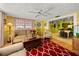 The living room has an open layout with a view into the dining room, and colorful decorations at 1491 Avenue F Ne, Winter Haven, FL 33881