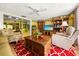 A colorful living room features cozy seating and a view into the dining area at 1491 Avenue F Ne, Winter Haven, FL 33881