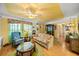 Inviting living room with floral sofa, ceiling fan and unique decor at 1491 Avenue F Ne, Winter Haven, FL 33881