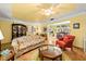 Cozy living room featuring a floral sofa, hardwood floors, and yellow walls at 1491 Avenue F Ne, Winter Haven, FL 33881