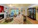 Comfortable living room with fireplace, unique decor, and floral valances at 1491 Avenue F Ne, Winter Haven, FL 33881